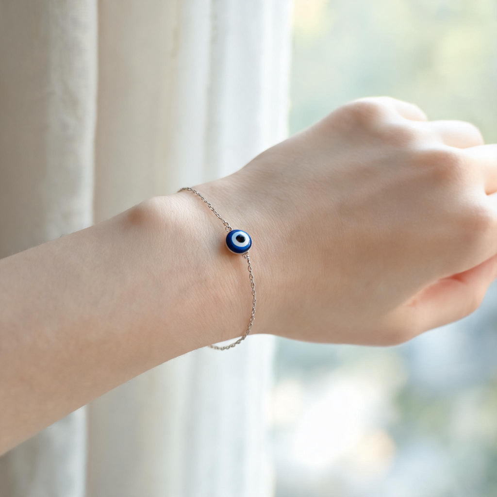Woman's wrist wearing handmade evil eye bracelet, adjustable cord