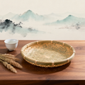Bamboo wall basket on wooden table with tea cup and dried grass